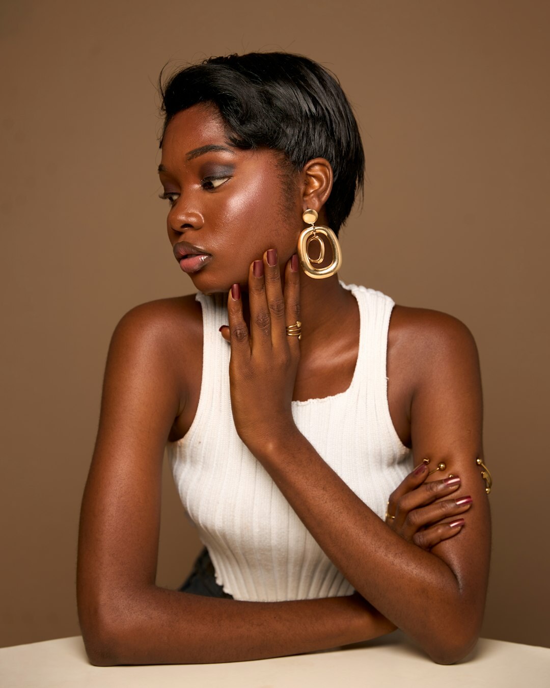 Elegant studio portrait of a European woman with sleek hairstyle and sophisticated expression