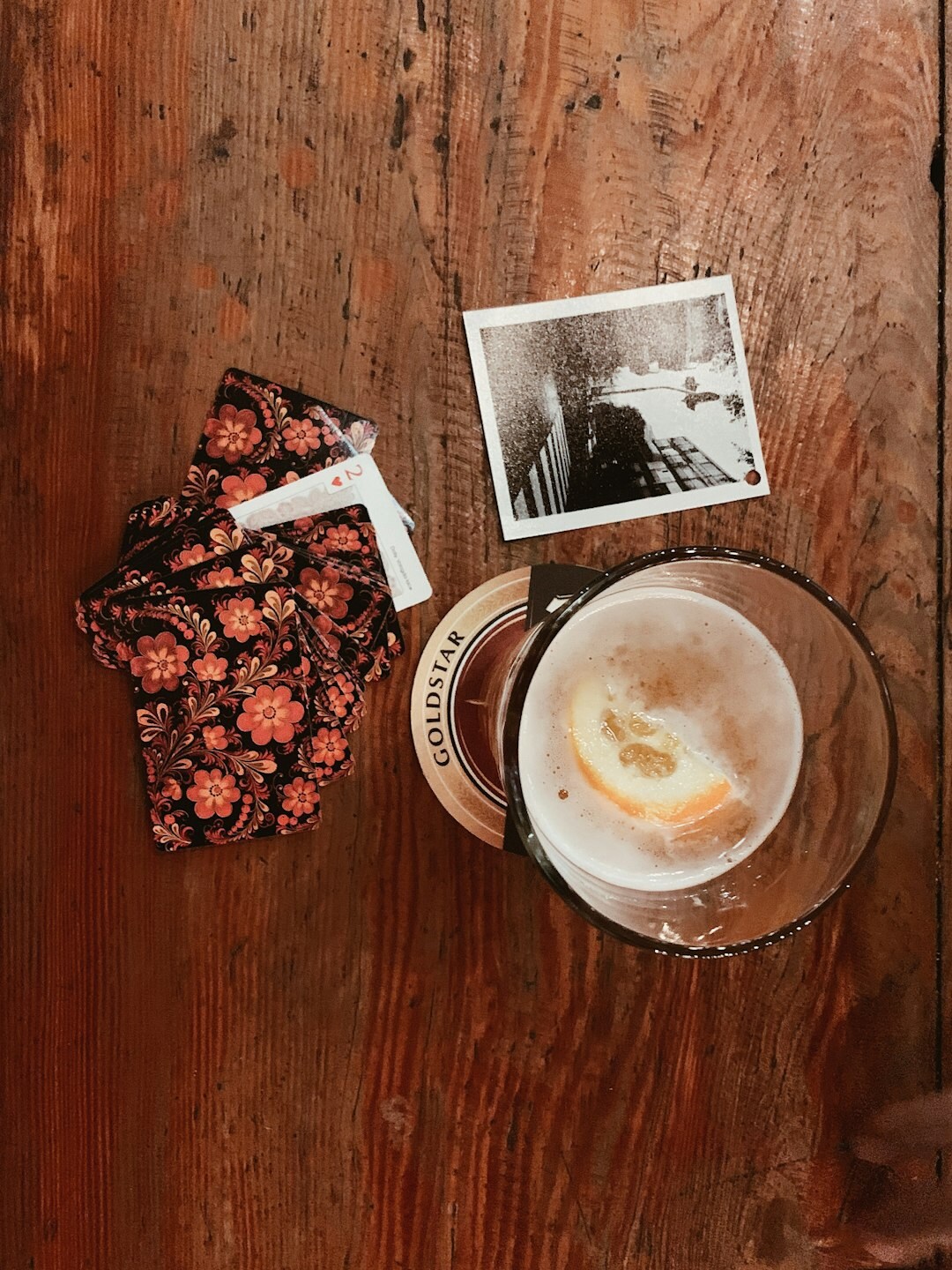 Vintage film reels and archival photographs arranged on a wooden table