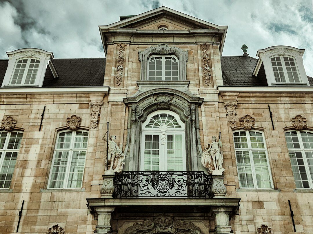 Elegant Belgian architecture with a classic stone facade and large windows